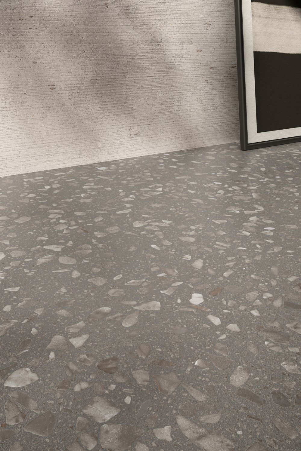 Detailaufnahme der Sant Agostino Glow Grey mit grauem Grundton und unterschiedlich großen hellen Steinfragmenten in moderner Terrazzo-Optik