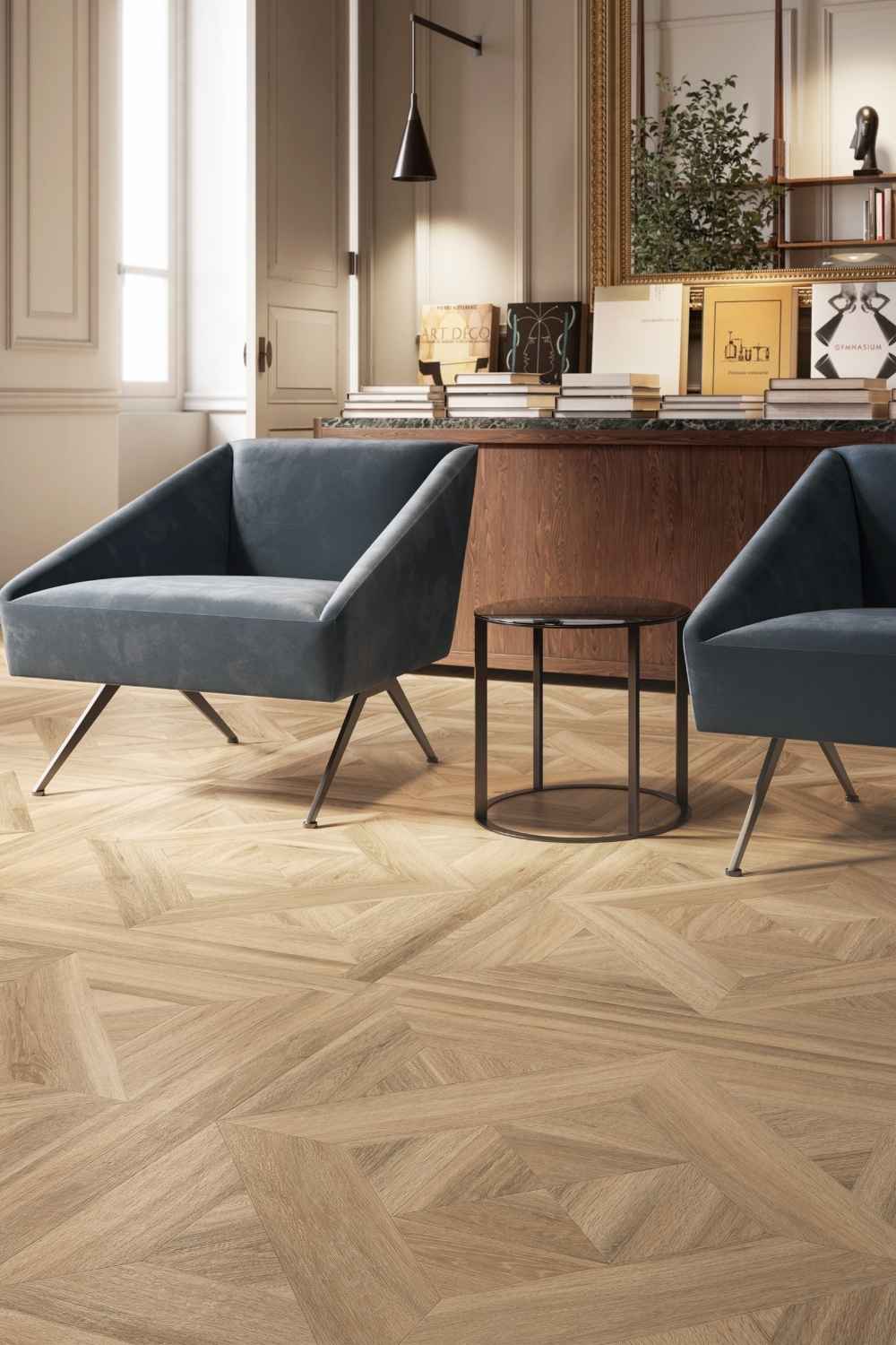 Sant Agostino Ricordi Glam 01 Barkwood Honey als Bodenfliese in warmer Holzoptik mit dekorativer Tafelparkett- und Kassettenparkett-Struktur in einem stilvollen Büro mit blauen Sesseln