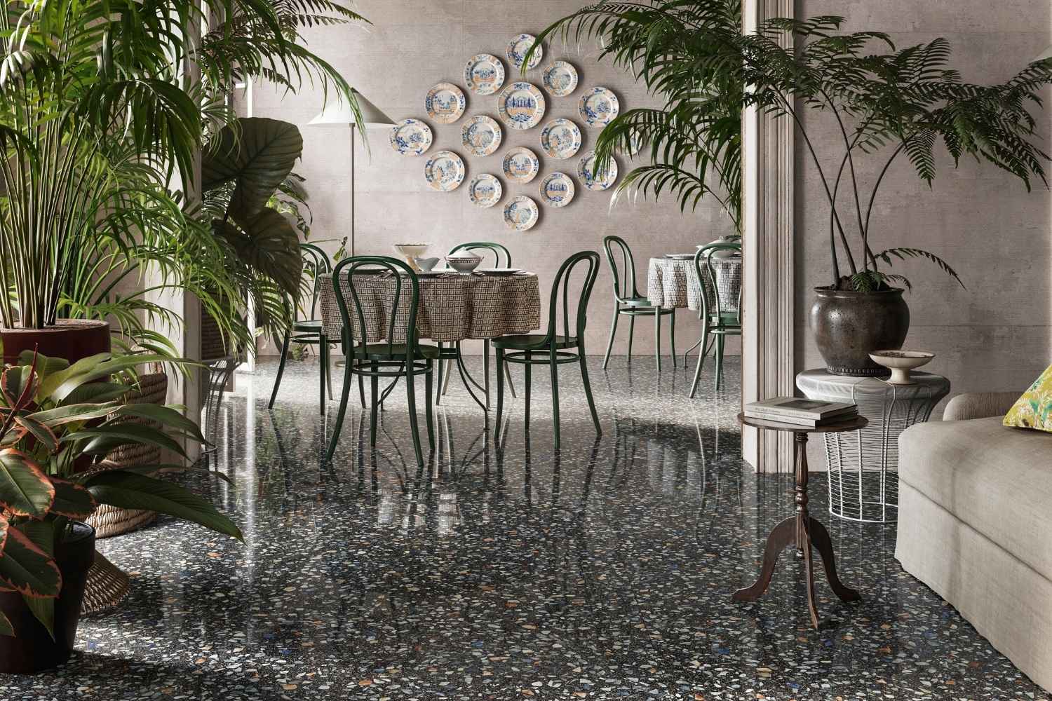 Sant Agostino Glow Plus Night glänzend poliert als dunkle Bodenfliese in Terrazzo-Optik im eleganten Wohn- und Essbereich mit vielen Pflanzen